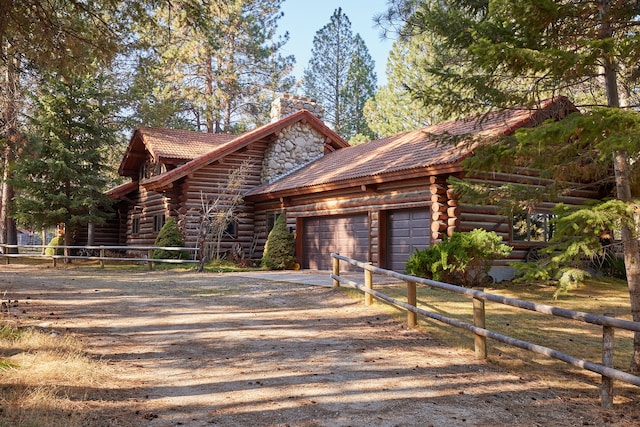 log cabin featuring a garage