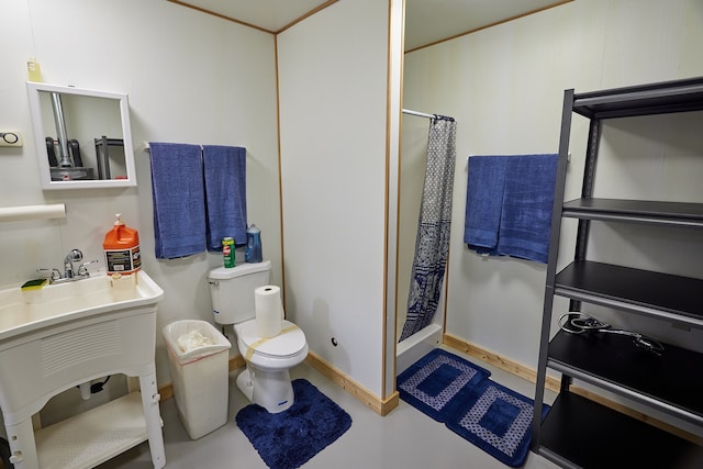 bathroom featuring concrete flooring, a shower with shower curtain, vanity, and toilet