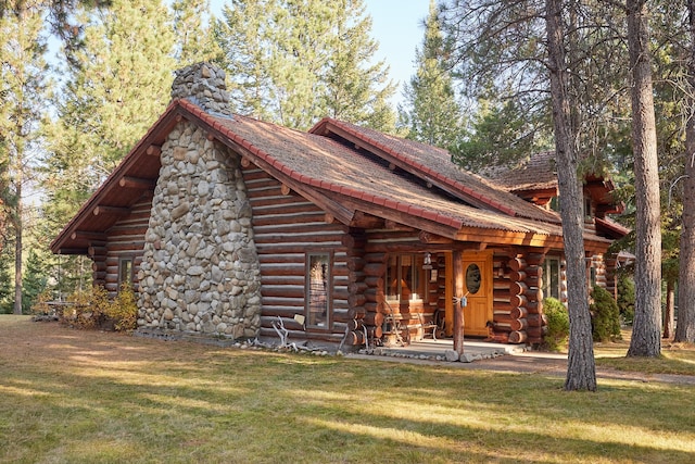 cabin with a front yard