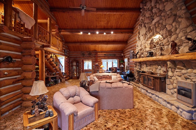 living room with ceiling fan, a stone fireplace, rail lighting, wood ceiling, and heating unit