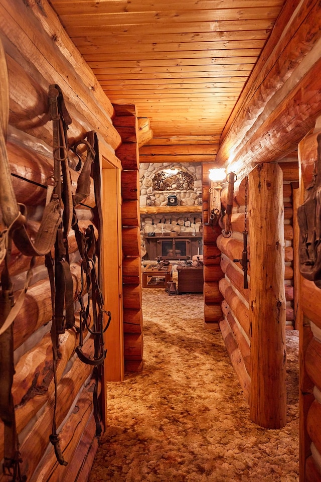 interior space with carpet, wooden ceiling, and log walls