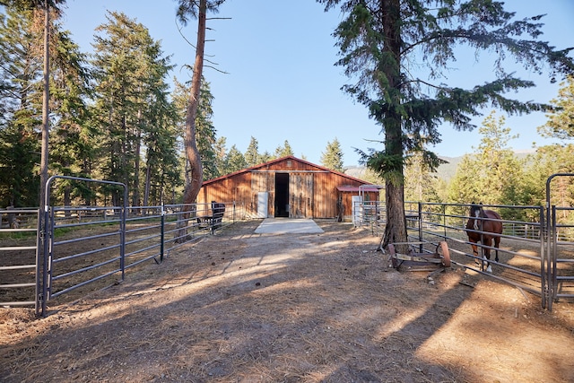 view of horse barn with a rural view