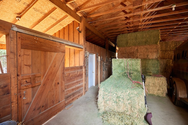 interior space featuring concrete flooring and vaulted ceiling