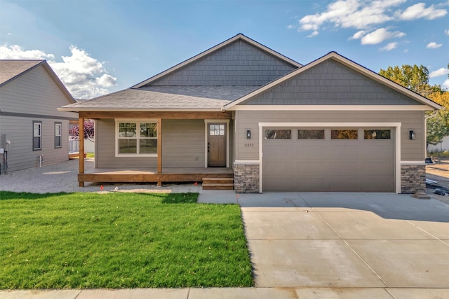 view of front facade with a front lawn, a porch, and a garage