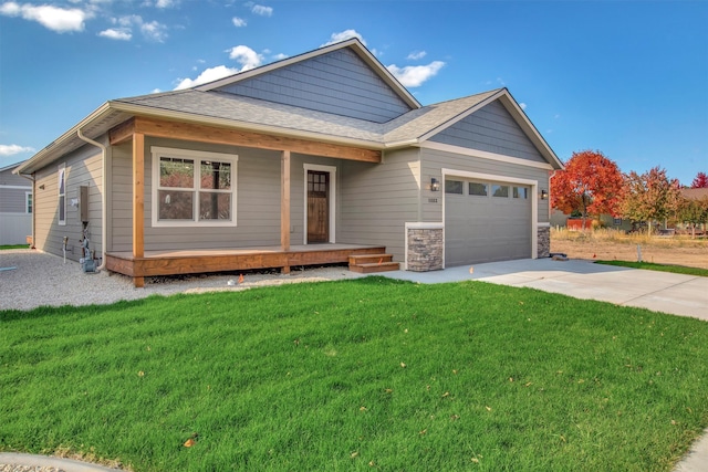 view of front facade with a garage, a porch, and a front yard