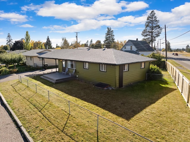 back of house featuring a yard, a deck, and a patio