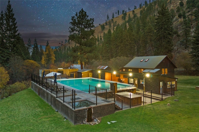 view of swimming pool featuring a patio area and a yard