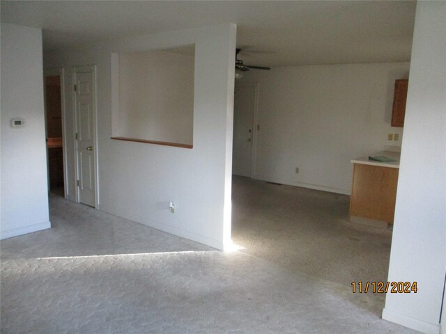 carpeted empty room with ceiling fan