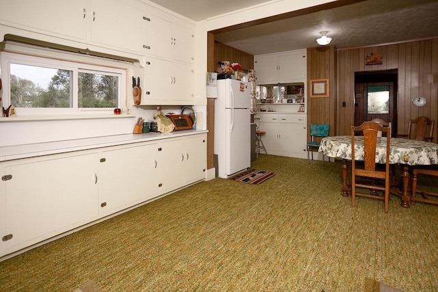 6058 Cottonwood Creek Rd, Lewistown, MT 59457 - kitchen featuring freestanding refrigerator, light countertops, white cabinetry, and wood walls