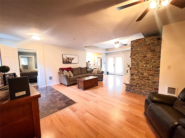 living room with ceiling fan and light hardwood / wood-style floors