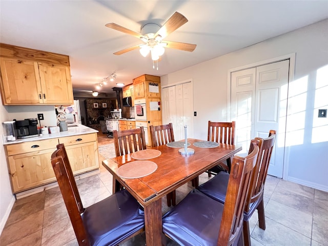 tiled dining area featuring sink and ceiling fan