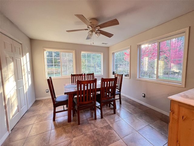 dining space with light tile patterned floors and ceiling fan