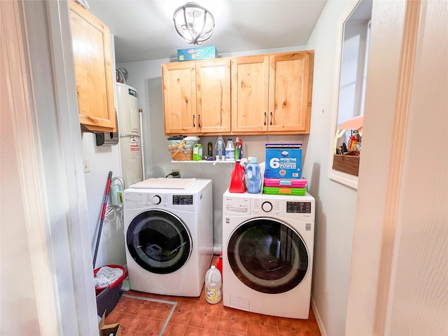 laundry area with cabinets, washing machine and dryer, light tile patterned floors, and water heater