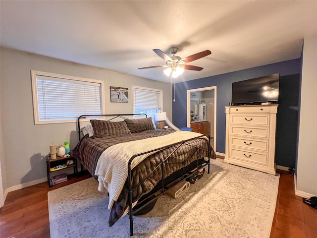 bedroom with dark hardwood / wood-style floors and ceiling fan