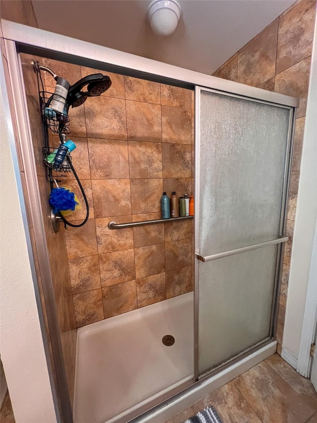 bathroom with a shower with shower door