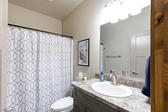 bathroom featuring curtained shower, vanity, and toilet