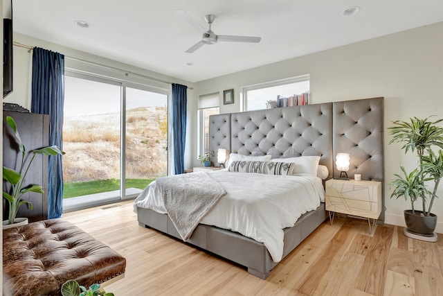 bedroom featuring access to exterior, ceiling fan, and light hardwood / wood-style flooring