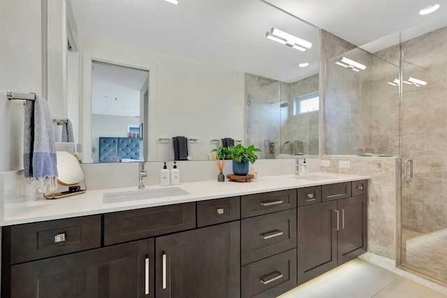 bathroom featuring walk in shower, vanity, and tile patterned flooring