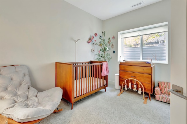 carpeted bedroom with a nursery area