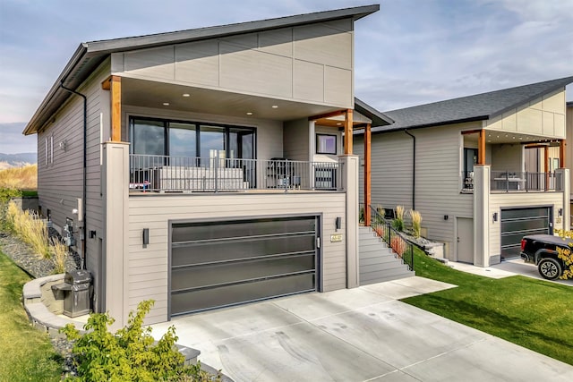 view of front facade with a balcony and a garage