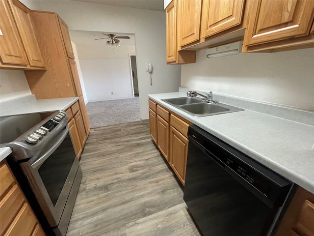 kitchen featuring light hardwood / wood-style floors, ceiling fan, black dishwasher, sink, and stainless steel range with electric stovetop