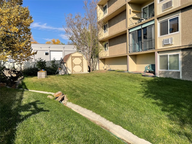 view of yard with a shed and a balcony