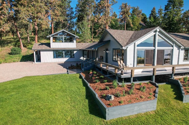 22700 Northaire Ln, Rollins, MT 59931 - rear view of property featuring a lawn, a shingled roof, and a deck
