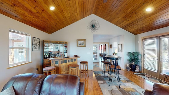 52772 Herak Rd, Charlo, MT 59824 - living room featuring lofted ceiling, wooden ceiling, light wood finished floors, and a bar
