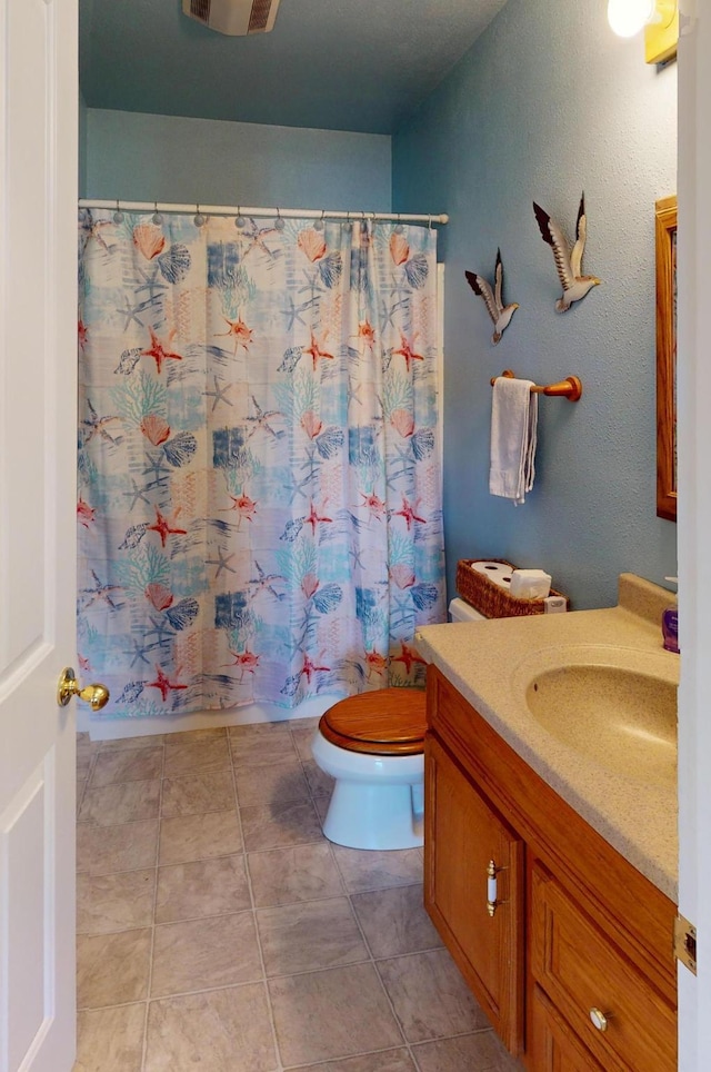 52772 Herak Rd, Charlo, MT 59824 - full bathroom with tile patterned flooring, toilet, and vanity