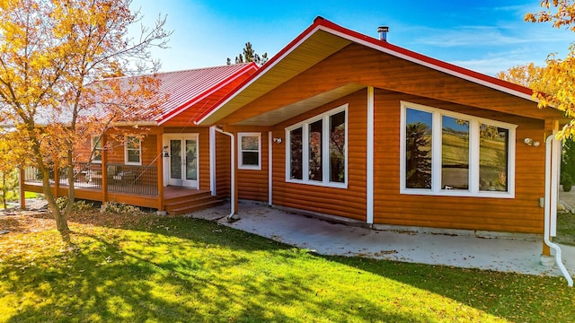 52772 Herak Rd, Charlo, MT 59824 - rear view of property with a yard, faux log siding, and a deck