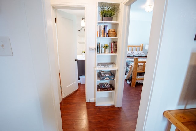 corridor with dark hardwood / wood-style flooring