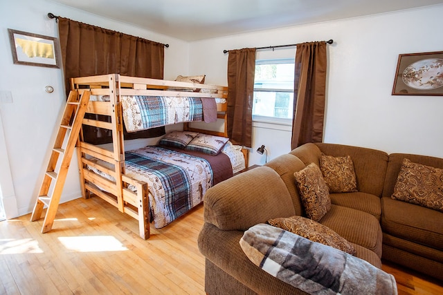 bedroom with wood-type flooring and ornamental molding