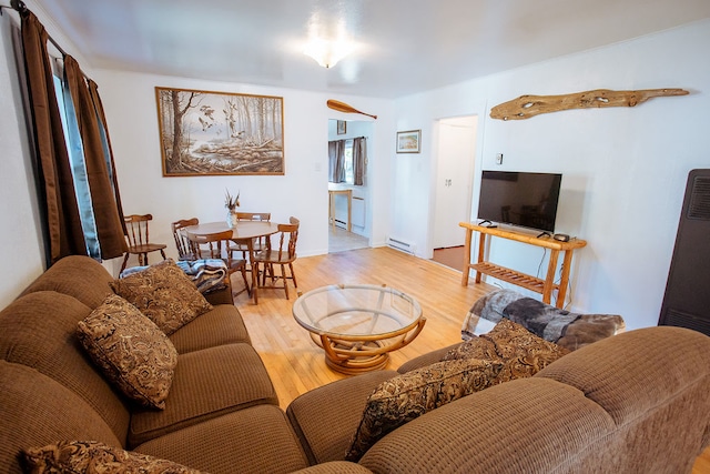 living room with light wood-type flooring and a baseboard radiator