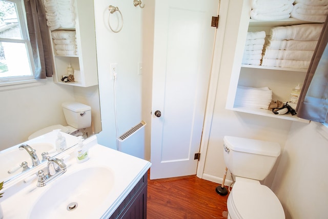 bathroom with vanity, toilet, and wood-type flooring