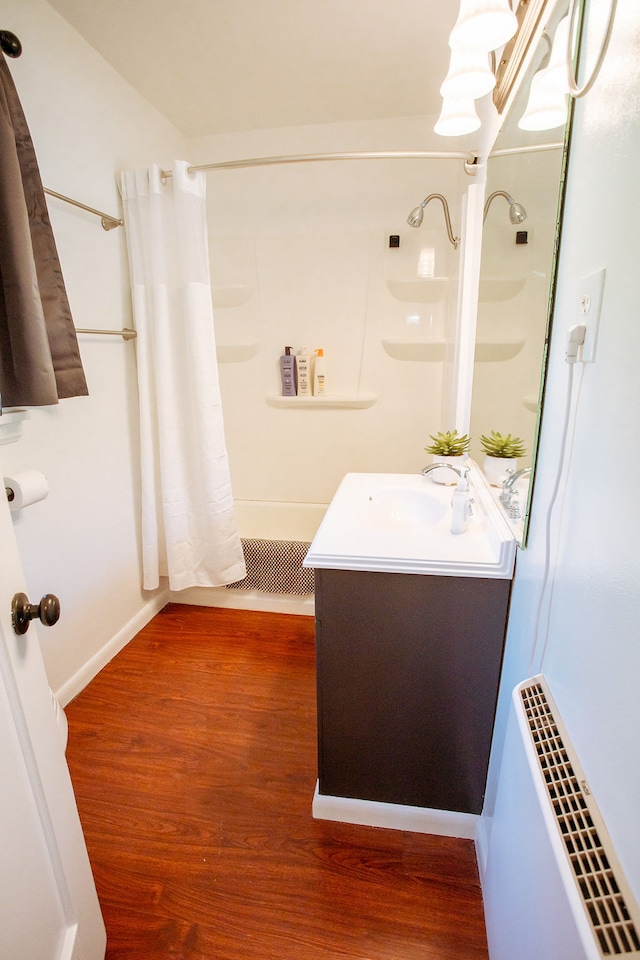 bathroom featuring a shower with shower curtain, hardwood / wood-style flooring, and vanity