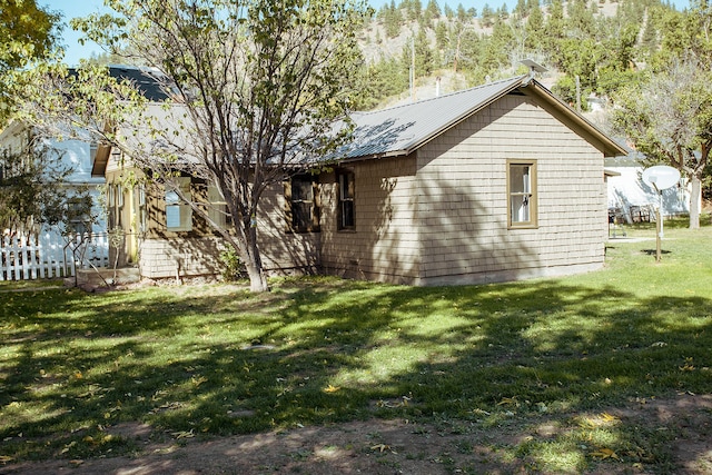 rear view of house featuring a lawn