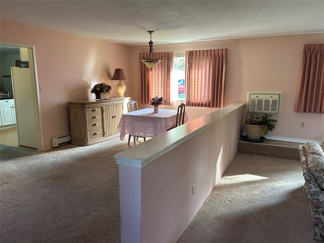 carpeted dining space featuring a textured ceiling and baseboard heating