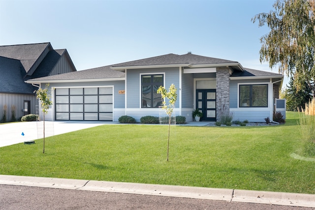 view of front of house featuring a garage and a front lawn