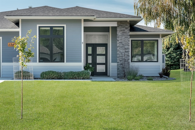 property entrance with a lawn