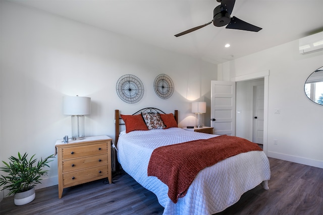 bedroom with dark hardwood / wood-style floors, a wall mounted AC, and ceiling fan