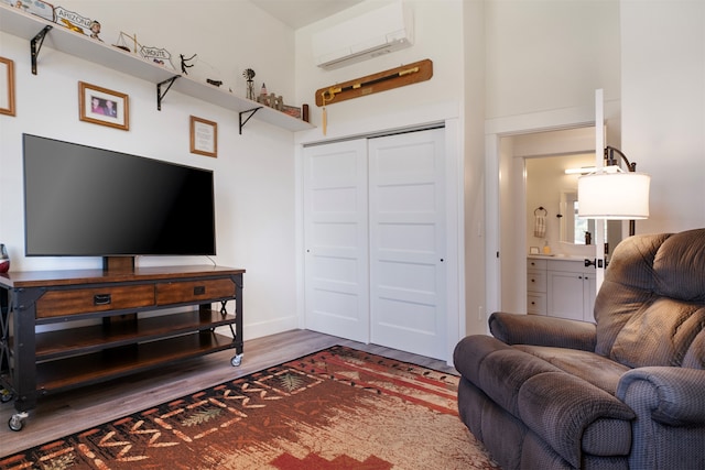 living room with an AC wall unit, a towering ceiling, and dark hardwood / wood-style flooring