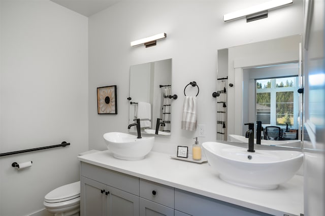 bathroom with toilet and vanity