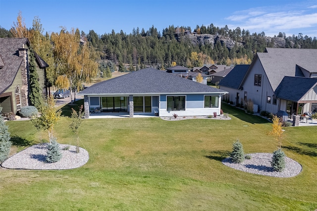 rear view of property featuring a yard