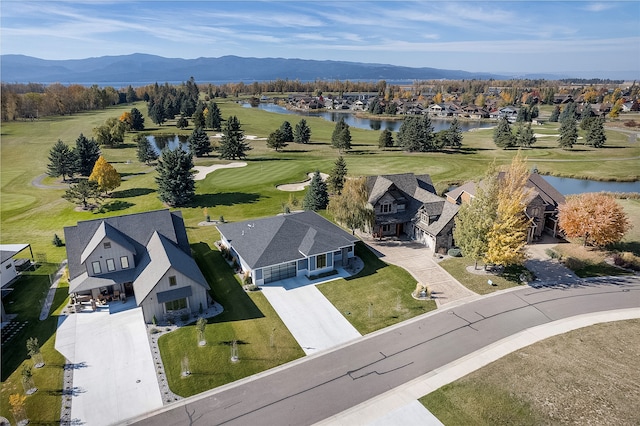 birds eye view of property with a water and mountain view