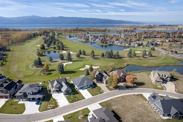 birds eye view of property with a water and mountain view