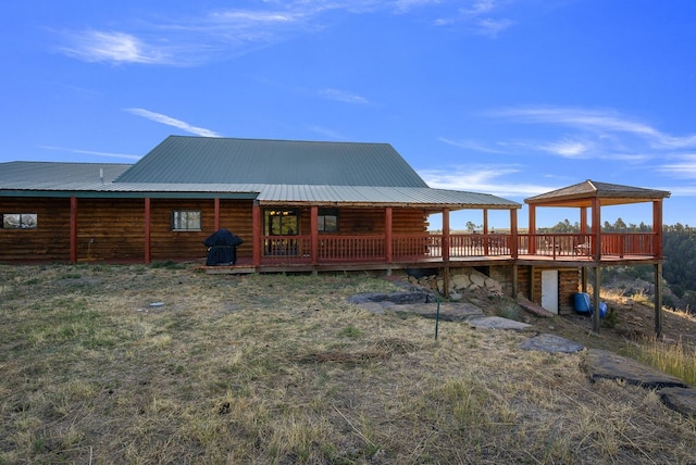 back of property with a wooden deck