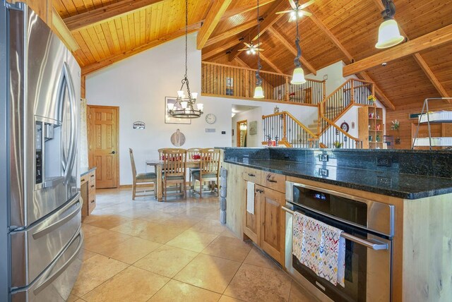 kitchen with pendant lighting, beamed ceiling, wood ceiling, high vaulted ceiling, and appliances with stainless steel finishes