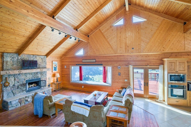 living room featuring high vaulted ceiling, tile patterned flooring, wooden ceiling, and french doors