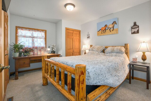 bedroom with light colored carpet and a closet