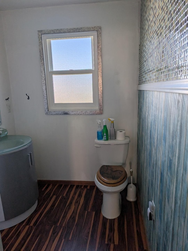 bathroom with hardwood / wood-style flooring and toilet